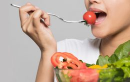 Beautiful-girl-eating-a-tomato