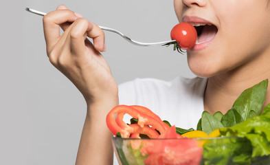 Beautiful-girl-eating-a-tomato